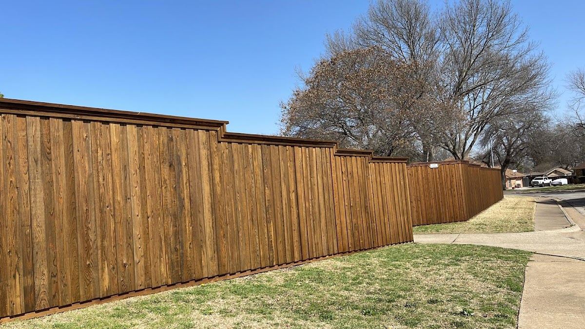 Freshly built cedar privacy fence stained along a Fort Worth corner lot